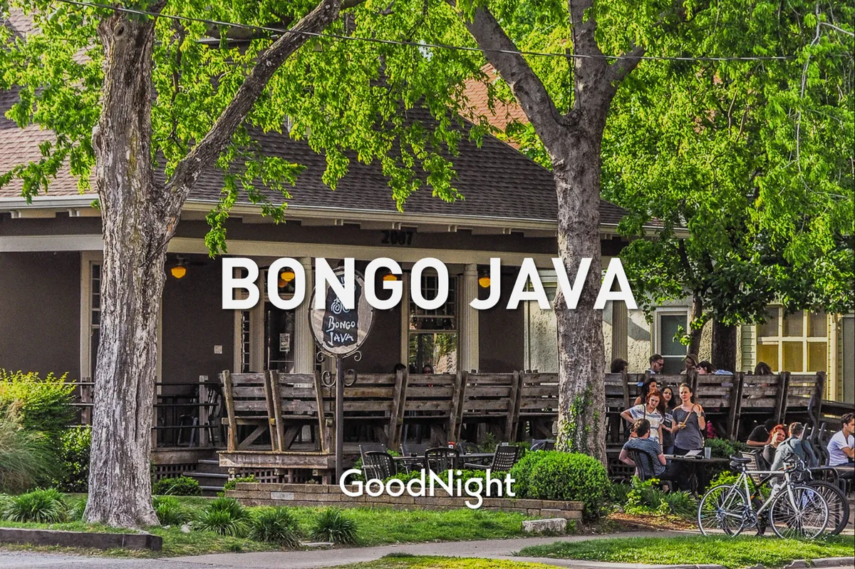 The outdoor patio of Bongo Java, a renowned local coffee shop, with inviting seating shaded by large trees and the recognizable Bongo Java sign. The communal, relaxed vibe is evident with people enjoying coffee and social interaction.